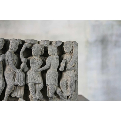 65 - A Gandharan carved schist panel, circa 3rd century. Depicting five female figures in robes, the cent... 