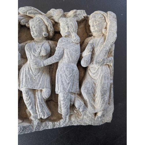 65 - A Gandharan carved schist panel, circa 3rd century. Depicting five female figures in robes, the cent... 