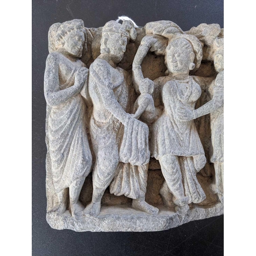 65 - A Gandharan carved schist panel, circa 3rd century. Depicting five female figures in robes, the cent... 