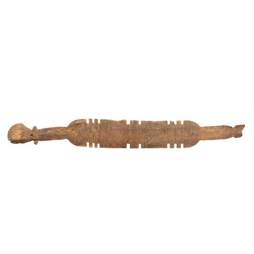 72 - Two Tuareg carved wood tent pegs. Each with bands of geometric motifs, height 76 and 72cm. (2)