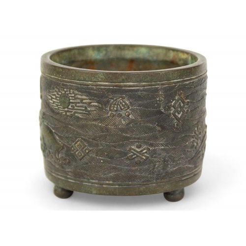 73 - A Chinese bronze incense burner, Qing Dynasty. The cylindrical body decorated with buffaloes in a la... 