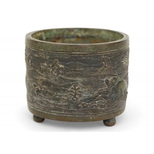 73 - A Chinese bronze incense burner, Qing Dynasty. The cylindrical body decorated with buffaloes in a la... 