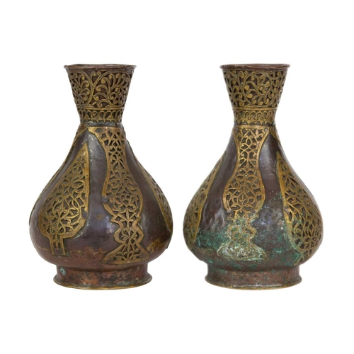 74 - A pair of Persian copper vases, 19th century. With overlaid brass tendrils, height 18.5cm, width 11c... 