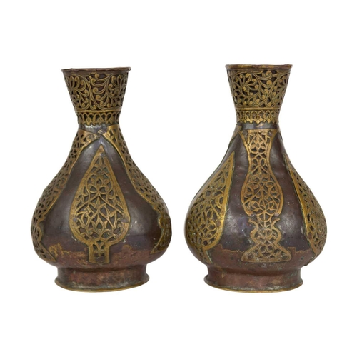 74 - A pair of Persian copper vases, 19th century. With overlaid brass tendrils, height 18.5cm, width 11c... 