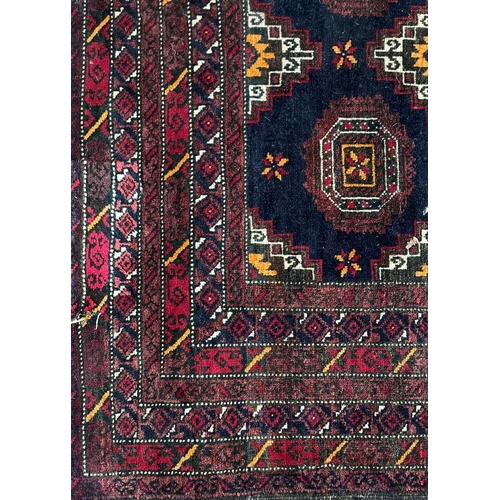 84 - An Afghan rug, circa 1930's. With six rows of two octagonal medallions, within multiple borders, 187... 