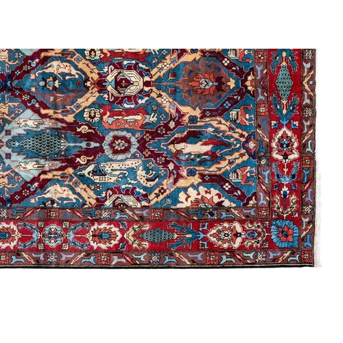 86 - An Isparta carpet, South West Anatolia. The blue field with polychrome trellis design and stylised b... 