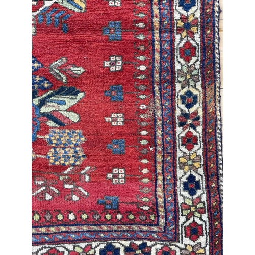 88 - An Afshar rug, South West Persia, circa 1930-1940. The red field with two central polychrome floral ... 