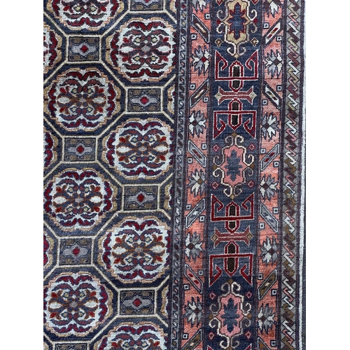 89 - A South Caucasian rug, circa 1930. With an all over design of linked octagonal medallions, within an... 