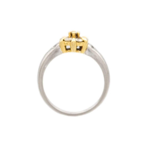 104 - An 18ct yellow and white gold diamond set cluster ring. The seven round brilliant cut diamonds each ... 