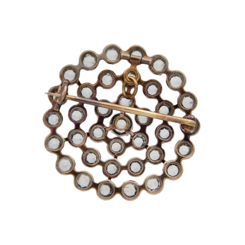 113 - An early 20th-century white sapphire silver and gold set circular openwork brooch. The stones set in... 