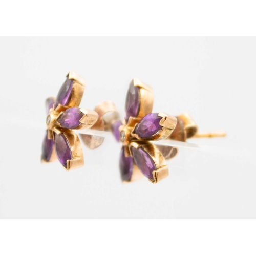 12 - A pair of Victorian 9ct rose gold amethyst and diamond set flower head earrings. With a central coll... 