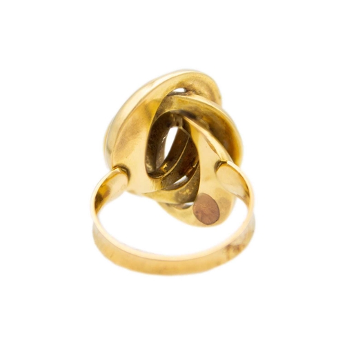 18 - An 18ct (tested) knot design ring. The hollow gold knot comprising three interlinked ovals, one is t... 