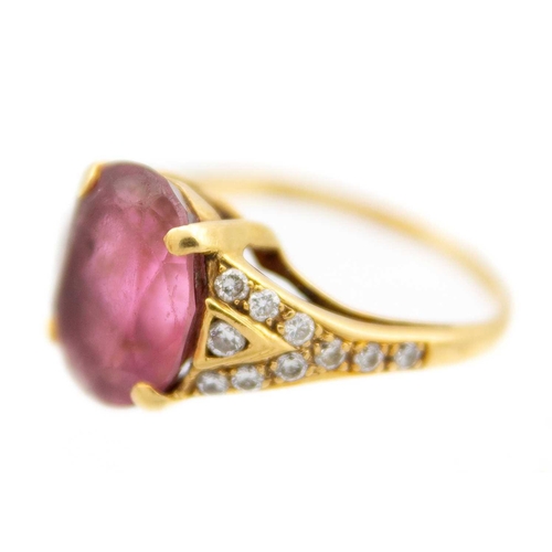 22 - An 18ct hallmarked gold pink Tourmaline and diamond set dress ring. The oval cut tourmaline weighing... 