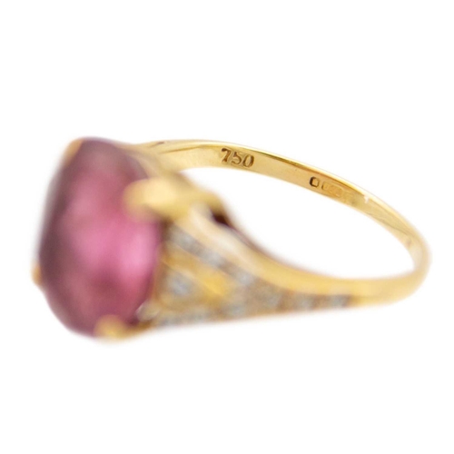 22 - An 18ct hallmarked gold pink Tourmaline and diamond set dress ring. The oval cut tourmaline weighing... 