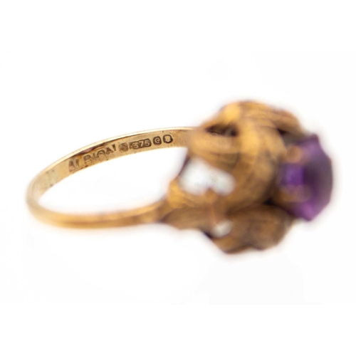 23 - Two 9ct hallmarked rose gold gem set rings. One set with a single round cut amethyst in a fancy open... 