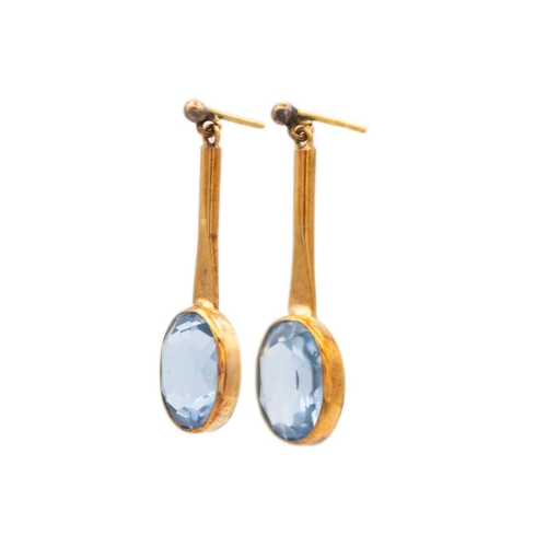 24 - A pair of early 20th century 9ct rose gold blue spinel set drop earrings. The oval cut spinels each ... 