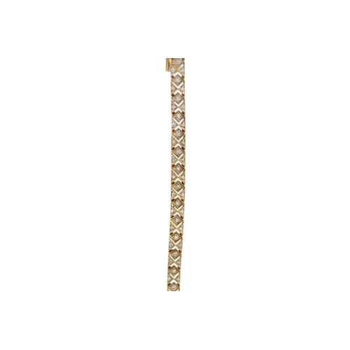 25 - A modern 9ct hallmarked gold diamond set bracelet. The bracelet with millegrain set tiny round brill... 