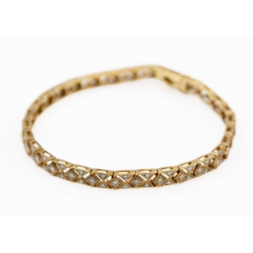 25 - A modern 9ct hallmarked gold diamond set bracelet. The bracelet with millegrain set tiny round brill... 