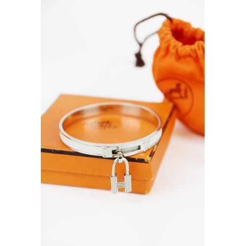 331 - HERMES - A Kelly H lock charm bangle in white metal and white leather. Within original bag and box.