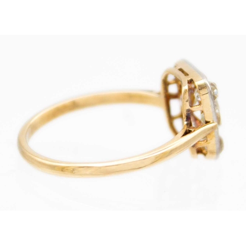 59 - An Art Deco 18ct yellow and white gold old mine cut set panel ring. The square head pave set with ni... 