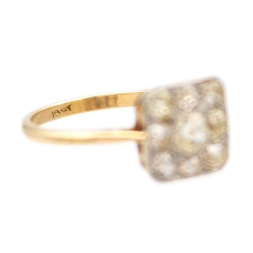 59 - An Art Deco 18ct yellow and white gold old mine cut set panel ring. The square head pave set with ni... 