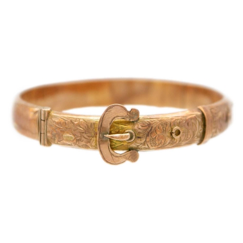 63 - An early 20th century 9ct rose gold hinged buckle bangle. Foliate scroll engraved, sponsors mark for... 