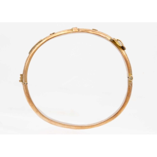 63 - An early 20th century 9ct rose gold hinged buckle bangle. Foliate scroll engraved, sponsors mark for... 