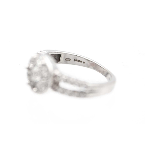 7 - A modern 14ct white gold diamond cluster dress ring. The circular head set with a 0.15ct approx. rou... 