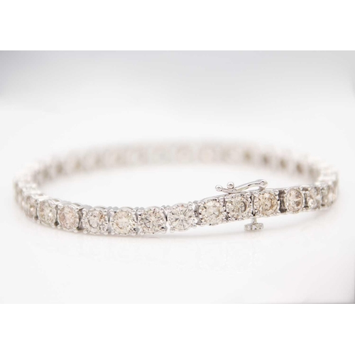 84 - An impressive 9ct white gold, 11.3ct diamond set line bracelet. Set with 35 round brilliant cut diam... 