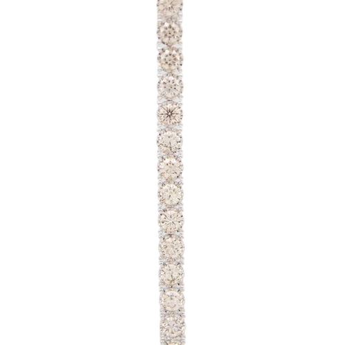 84 - An impressive 9ct white gold, 11.3ct diamond set line bracelet. Set with 35 round brilliant cut diam... 