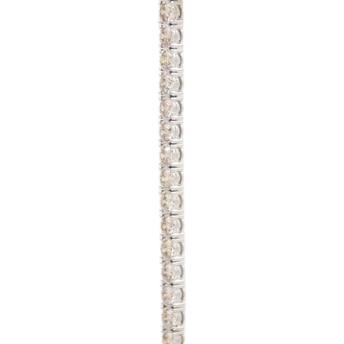 84 - An impressive 9ct white gold, 11.3ct diamond set line bracelet. Set with 35 round brilliant cut diam... 