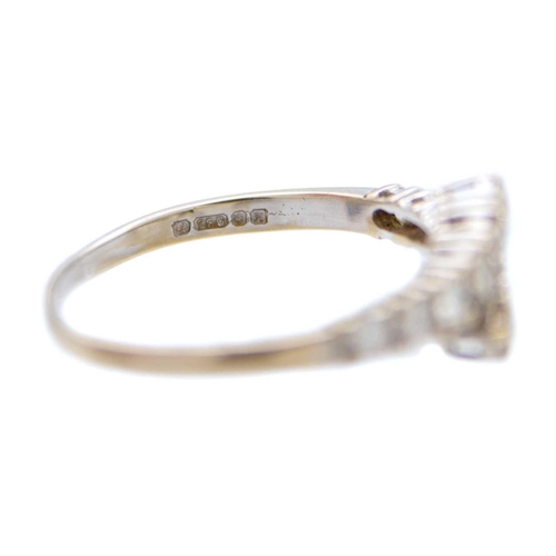 86 - A modern 18ct white gold diamond set twelve stone crossover style ring. The round brilliant cut diam... 