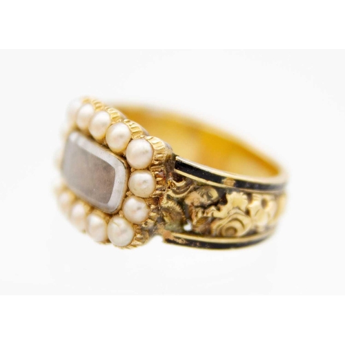 93 - A George IV 18ct hallmarked gold and black enamel seed pearl set memorial ring. The oblong head with... 