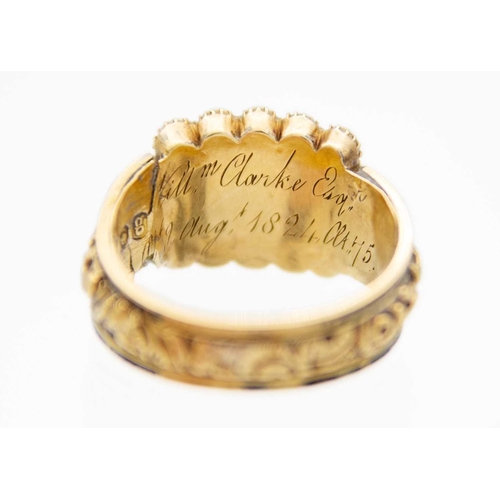 93 - A George IV 18ct hallmarked gold and black enamel seed pearl set memorial ring. The oblong head with... 