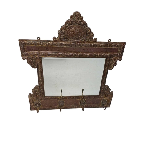 104 - A Low Countries stamped brass wall mirror/coat hook. Early 20th century, fitted with four lion mask ... 