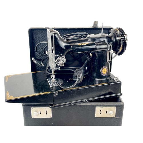 116 - A Singer Electric Sewing Machine No.221K. Serial No. EG 349320 1951 date with black case and accesso... 