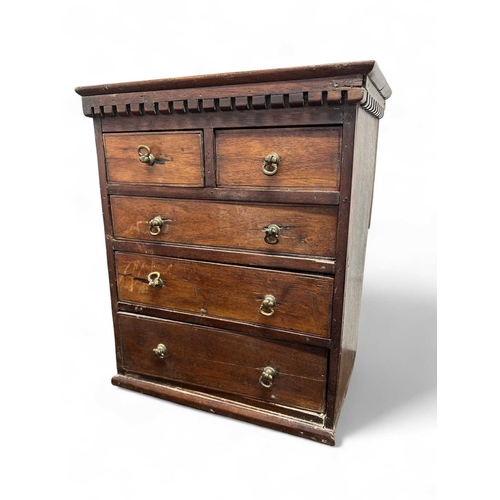 117 - A miniature mahogany small chest or apprentice piece. With a dentil cornice above two short and thre... 