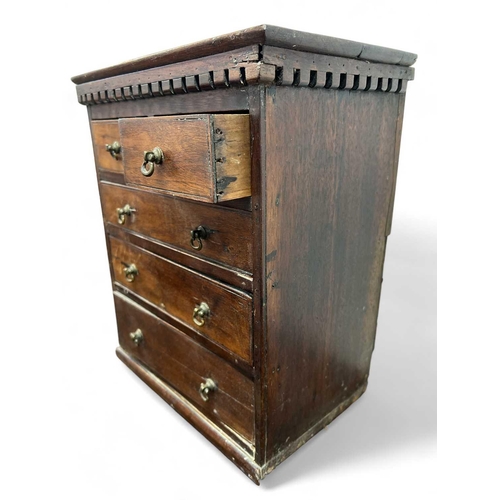 117 - A miniature mahogany small chest or apprentice piece. With a dentil cornice above two short and thre... 