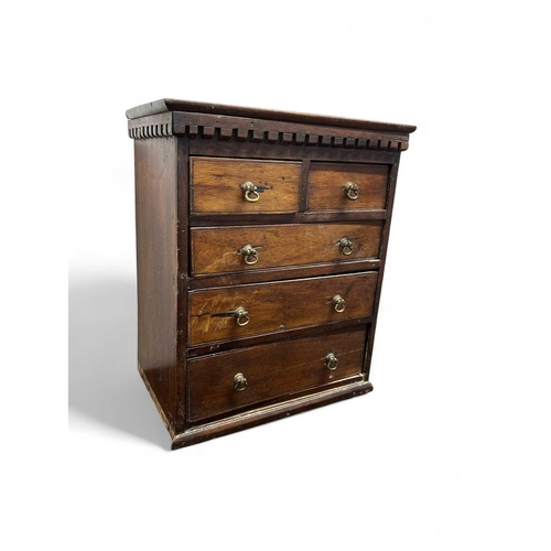 117 - A miniature mahogany small chest or apprentice piece. With a dentil cornice above two short and thre... 