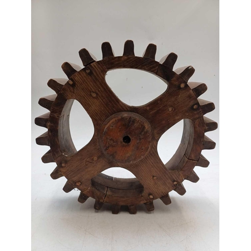 130 - Two hardwood cog patterns One stamped number 404, and the other 7, the larger 38.5cm diameter (2).