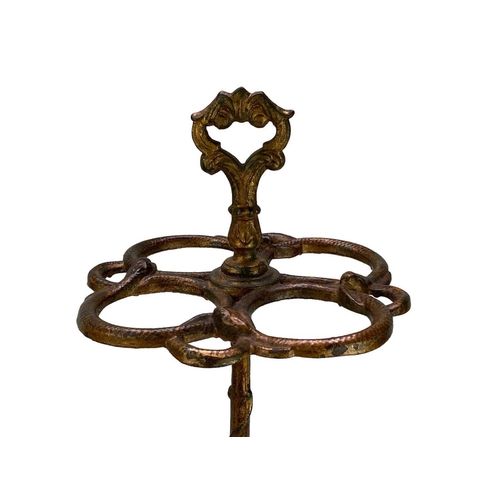 140 - A late Victorian cast iron stick stand. With four large divisions and four smaller divisions modelle... 