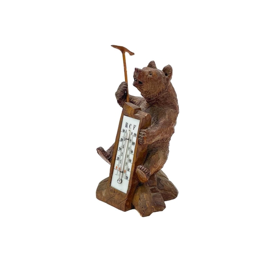 144 - A Black Forest carved bear desk barometer. Inscribed RAGAZ, height 21cm, together with an ebonised c... 