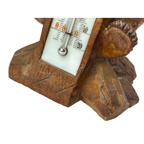 144 - A Black Forest carved bear desk barometer. Inscribed RAGAZ, height 21cm, together with an ebonised c... 