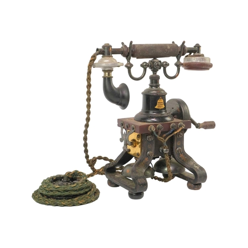 163 - A L M Ericsson & Co skeletal telephone. Height 30cm. The winding crank turns but with some friction,... 