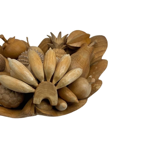 174 - A treen carved shell shaped fruit bowl and various fruits. Width 52cm.