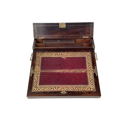 178 - A Regency rosewood lap desk or writing box. With fret cut brass banding and inlay, the eagle topped ... 