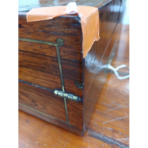 178 - A Regency rosewood lap desk or writing box. With fret cut brass banding and inlay, the eagle topped ... 