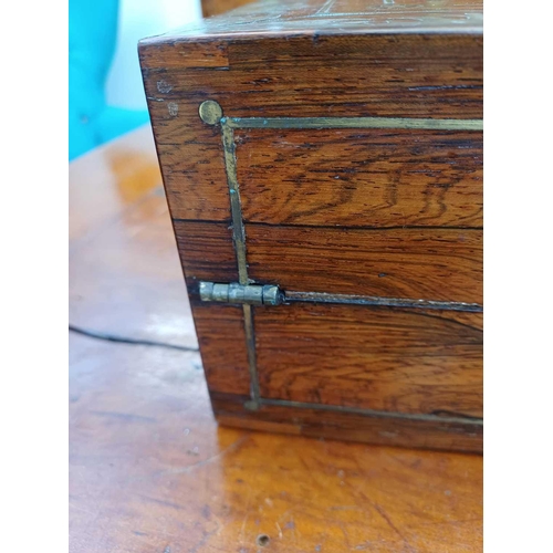 178 - A Regency rosewood lap desk or writing box. With fret cut brass banding and inlay, the eagle topped ... 