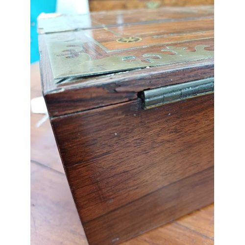 178 - A Regency rosewood lap desk or writing box. With fret cut brass banding and inlay, the eagle topped ... 