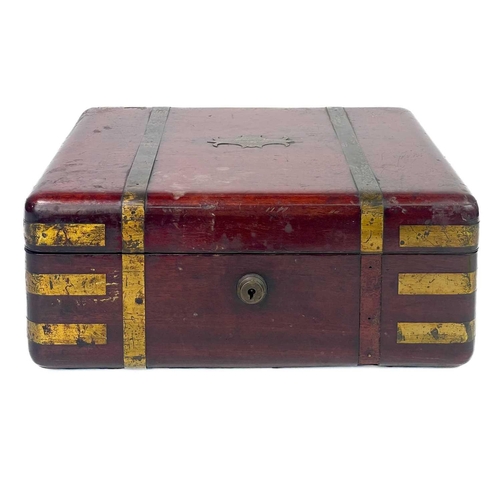 183 - A good William IV mahogany and brass bound campaign dressing case. The inside lid with a descriptive... 